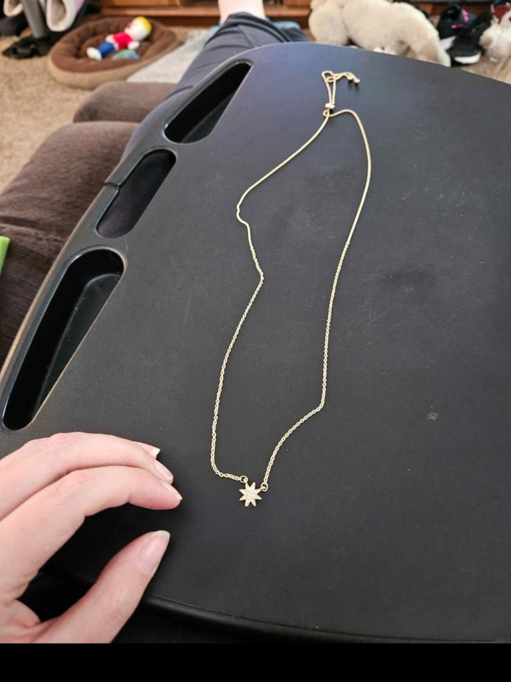 Gold necklace with a delicate starburst pendant